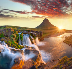  Beautiful landscape with sunrise on Kirkjufellsfoss waterfall and Kirkjufell mountain, Iceland, Europe.