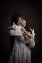 Portrait Of Young Girl In White Gown Holding Her Sweet White Cat In Painterly Studio Style