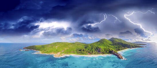 Wall Mural - Aerial panoramic view of Tropical Island with storm approaching. Climate change concept