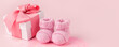 © misskaterina - Close up of baby shoes, present gift box - sweetness and baby booties on pink background, first newborn party background, birthday, gift present giving concept, celebrate card
