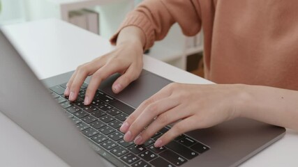 Fototapete - close-up of woman hands typing on laptop keyboard on the table.