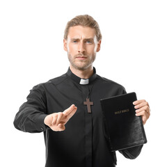 Wall Mural - Handsome priest with Bible on white background