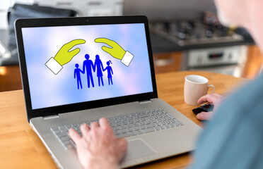 Wall Mural - Family protection concept on a laptop