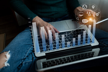 Hands of businesswoman working with laptop computer at  home with network interface icons. Double exposure and technology Concept.	