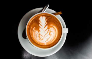 Cup of coffee latte isolated on black background	