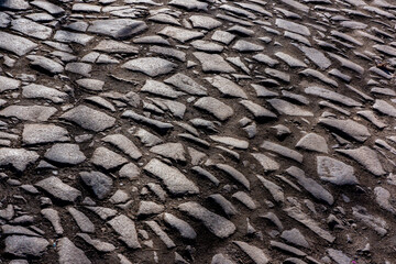 surface of an old stone road in the morning.