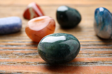 Wall Mural - Beautiful gemstones on wooden table, closeup. Healing crystals