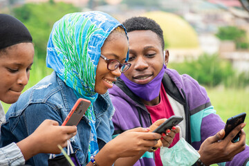 Wall Mural - young africans using their mobile phones together