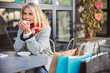 © Viacheslav Yakobchuk - Thoughtful mature woman with shopping bags sitting in the cafe