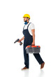 © LIGHTFIELD STUDIOS - Handsome workman in overalls and hardhat holding toolbox and electric screwdriver while walking on white background