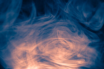 Wall Mural - clouds of colored flowing smoke on a dark background.
