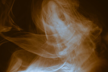 Wall Mural - clouds of colored flowing smoke on a dark background.