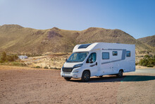 Caravan Motor Home Parked On Desertic Nature Landscape On A Sunny Day
