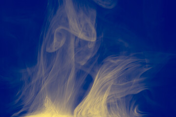Wall Mural - clouds of colored flowing smoke on a dark background.