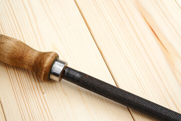 old steel file tool on the pinewood table