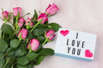  on a pink background a bouquet of pink roses and the inscription I love you