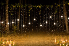 Wedding Ceremony Evening With Candles And Lamps In The Coniferous Pine Forest