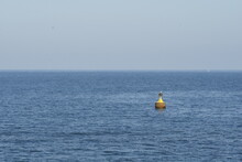 View Of Yellow Buoy In The Middle Of Calm Blue Sea