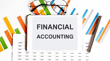 Poster - The tablet with text FINANCIAL ACCOUNTING on business charts and pen