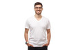 © Damir Khabirov - Front template of young man standing with hands in pockets, wearing blank tshirt with copy space and glasses, isolated on white background