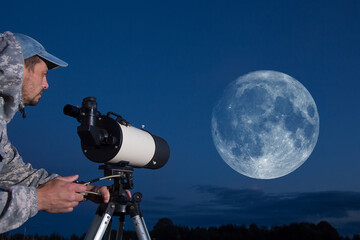 Wall Mural - a european man is watching the moon through a telescope. amateur astronomer.