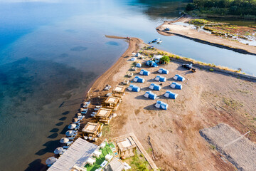 Wall Mural - Camping area, camping tent and caravan area, view of sea and stream. Travel and alternative holiday Tourism concept. Aerial view from drone. Selimiye, Marmaris - TURKEY