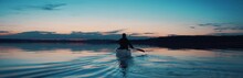 WIDE Man Canoeing In A Traditional Wooden Boat On A Large Lake At Dawn. Shot On RED Cinema Camera With 2x Anamorphic Lens