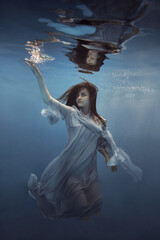 Wall Mural -   Portrait of a girl in a blue dress under water      