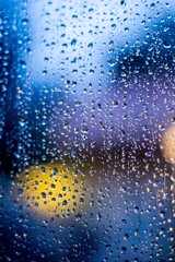 Sticker - Vertical closeup shot of a glass covered with raindrops