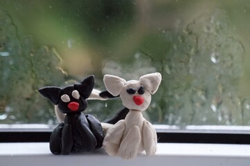 Sticker - Figures of two cats on the background of a wet window.