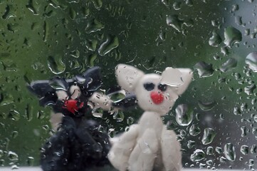 Sticker - Figures of two cats on the background of a wet window.