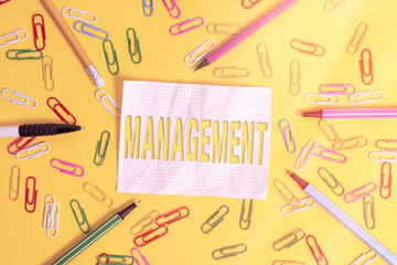 Poster - Writing note showing Management. Business concept for the authoritative act of directing or controlling things Flat lay above empty paper with pencils and paper clips