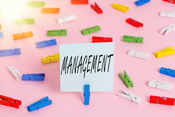 Poster - Word writing text Management. Business photo showcasing the authoritative act of directing or controlling things Colored clothespin papers empty reminder pink floor background office pin