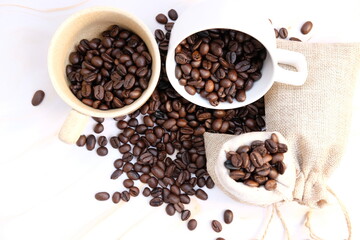 Poster - Top view coffee cup and coffee beans on wood table, space for text