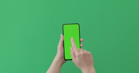 Sticker - Young female hand touch smartphone with green screen on green background