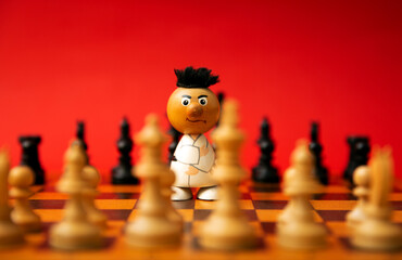 carat figure stands protectiuely on a chessboard against a red background