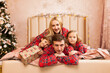 © Inna Vlasova - cheerful family lying down near Christmas tree at home