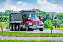 Large Dump Truck Delivering Gravel To Commercial Construction Site
