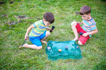 Two boys playing with a spinning top kid toy. Popular children game tournament.