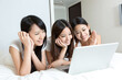 © JodieWang - Pretty young girls   using laptop in bedroom