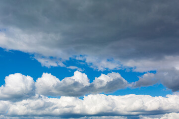 Wall Mural - Gray clouds on blue sky background. Stormy skies.