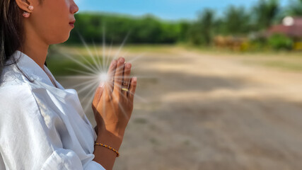 Asian women pray to God in the hot summer. The epidemic of kovid-19 has spread all over the world. She lives in a terrible environment. I hope everything will soon return to normal and happy life.