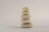 Fototapeta Desenie - One simplicity stones cairn isolated on white background, group of five white pebbles in tower