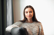 © VERSUSstudio - Young woman pretty relaxing on couch in living room