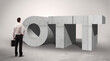 © ra2 studio - Rear view of a businessman standing in front of OTT abbreviation, modern technology concept