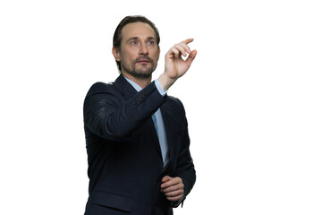 Portrait of thoughtful businessman using virtual screen on white background. Mature man in the suit isolated on white background.