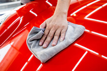 Car Service Worker Polishing Car With Microfiber Cloth.