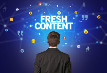 rear view of a businessman with fresh content inscription, social networking concept