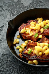 Wall Mural - Roasted Pork chops with caramelized apples, walnuts and sage in a cast iron pan