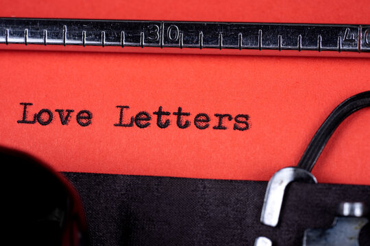 Love letters text written on a red paper of a old typewriter